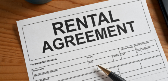 view of a rental agreement document on a wooden desk surface, featuring Ejari's Sharia-compliant Rent Now, Pay Later platform information